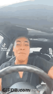 A Man Is Driving A Car With A Steering Wheel And Making A Funny Face . GIF