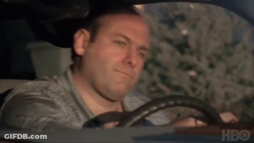 A Man Is Driving A Car With Hbo Written On The Bottom Of The Screen . GIF