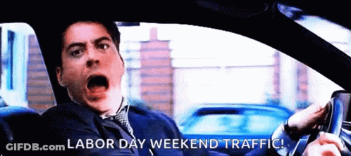 A Man Is Driving A Car With The Words Labor Day Weekend Traffic Written On The Screen GIF