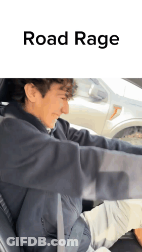 A Man Is Driving A Car With The Words Road Rage Written On The Bottom GIF