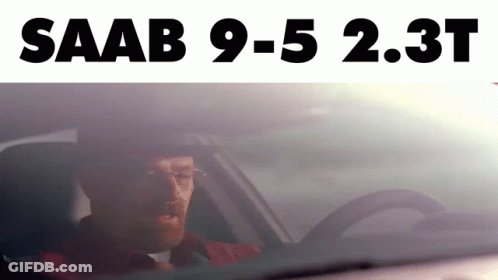 A Man Is Driving A Car With The Words Saab 9-5 2.3T Above Him GIF