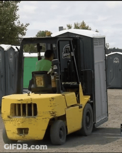 A Man Is Driving A Forklift With A BBC Logo On The Back GIF