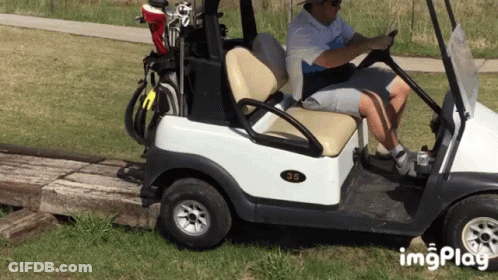 A Man Is Driving A Golf Cart With The Number 35 On The Back GIF