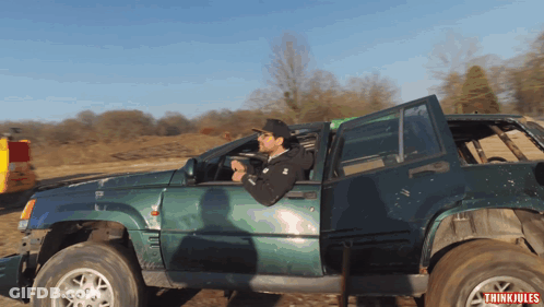 A Man Is Driving A Green Jeep With The Word Thinkiules On The Bottom Right GIF