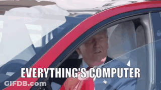 A Man Is Driving A Red Car With The Words " Everything 'S Computer " On The Bottom GIF