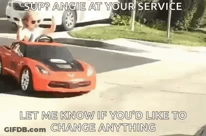 A Man Is Driving A Red Toy Car On A Street . GIF