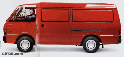 A Man Is Driving A Red Van That Says Mitsubishi On It GIF