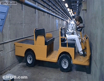 A Man Is Driving A Small Yellow Vehicle That Says South State On The Side GIF