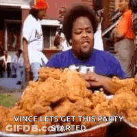 A Man Is Eating A Large Bowl Of Fried Chicken . GIF