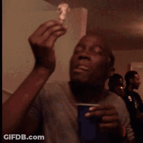 A Man Is Eating A Piece Of Cake With A Smile On His Face GIF
