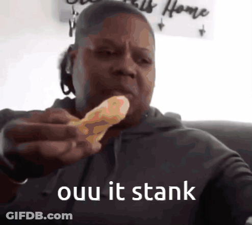 A Man Is Eating A Piece Of Pizza With The Words " Ouu It Stank " Written Below Him GIF
