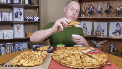 A Man Is Eating A Pizza And Dipping It In Ranch Dressing GIF