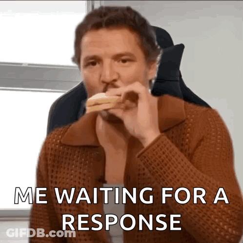 A Man Is Eating A Sandwich With The Words " Me Waiting For A Response " Below Him GIF
