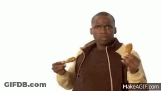 A Man Is Eating Chicken Wings And Listening To Music With Headphones . GIF