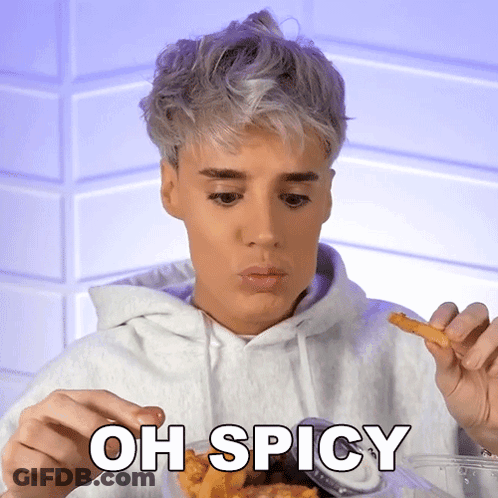 A Man Is Eating French Fries With The Words Oh Spicy Written Below Him GIF