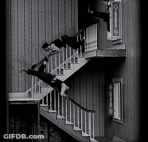 A Man Is Falling Down A Set Of Stairs In A Black And White Photo GIF