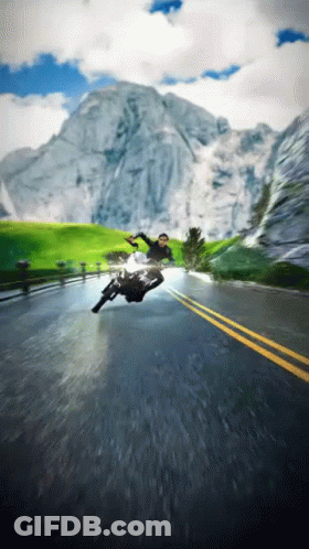 A Man Is Falling Off A Motorcycle On A Road GIF