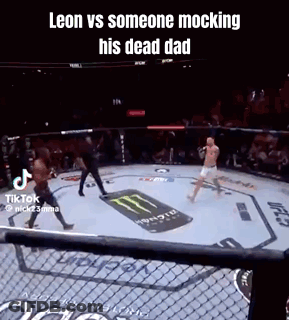 A Man Is Fighting Another Man In A Boxing Ring With A Monster Energy Logo On The Ground . GIF