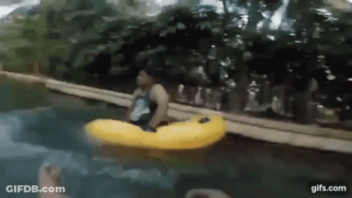 A Man Is Floating On A Yellow Raft In The Water . GIF
