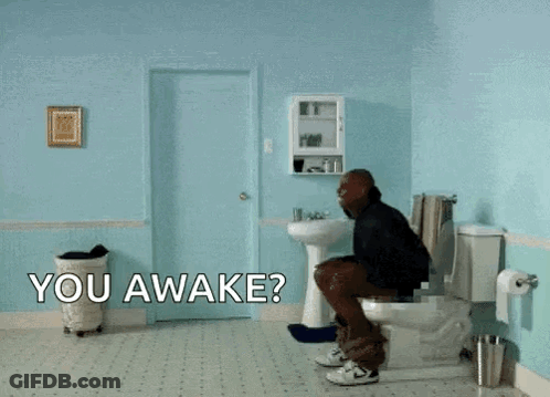 A Man Is Flying Through The Air In A Bathroom With The Words " You Awake " On The Floor GIF