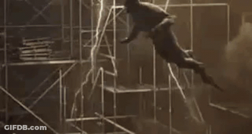 A Man Is Flying Through The Air While Holding A Light . GIF