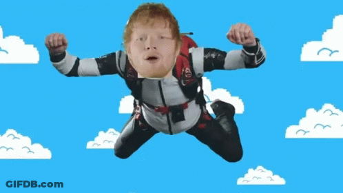 A Man Is Flying Through The Air With A Parachute On His Back That Says Ed Sheeran GIF