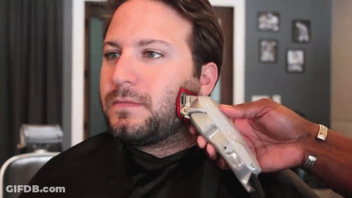 A Man Is Getting His Beard Trimmed With A Wahl Brand Clipper GIF
