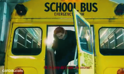 A Man Is Getting Off A Yellow School Bus With His Door Open . GIF