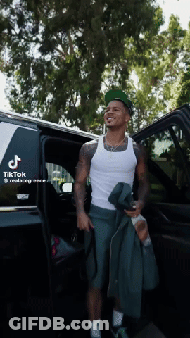 A Man Is Getting Out Of A Car With A Tik Tok Sticker On The Back GIF