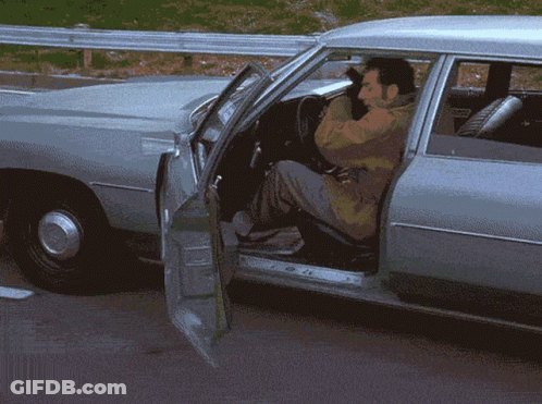 A Man Is Getting Out Of A Car With His Door Open GIF