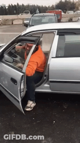 A Man Is Getting Out Of A Car With The Door Open GIF