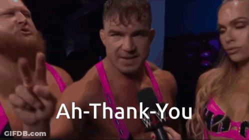 A Man Is Giving A Peace Sign While A Woman Holds A Microphone And Says " Ah-Thank-You " GIF