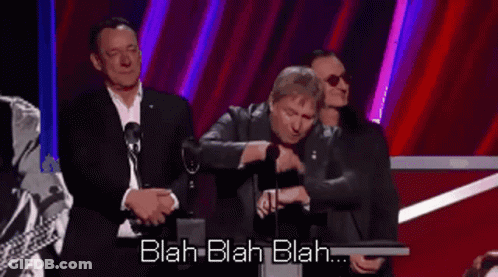A Man Is Giving A Speech At A Podium With The Words Blah Blah Blah Behind Him GIF