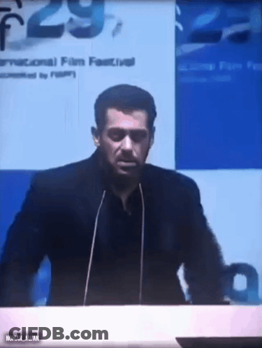 A Man Is Giving A Speech In Front Of A Microphone At A Conference . GIF