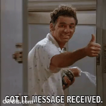 A Man Is Giving A Thumbs Up In A Bathroom While Holding A Hose . GIF