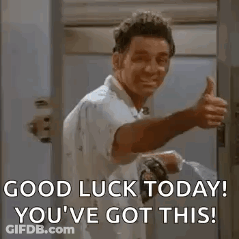 A Man Is Giving A Thumbs Up In A Doorway While Holding A Hose . GIF
