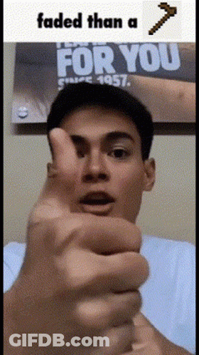 A Man Is Giving A Thumbs Up In Front Of A Poster That Says " For You " GIF