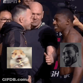 A Man Is Giving A Thumbs Up To Another Man In Front Of A Crowd . GIF