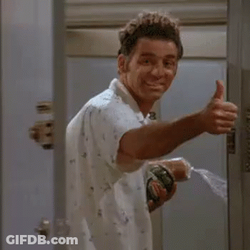 A Man Is Giving A Thumbs Up While Holding A Spray Bottle In His Hand . GIF