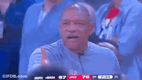 A Man Is Giving A Thumbs Up While Watching A Basketball Game On Espn . GIF