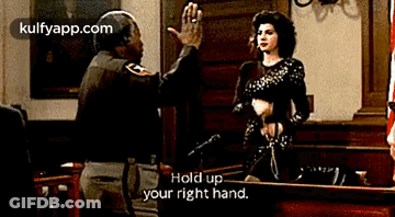 A Man Is Giving A Woman A High Five In A Courtroom While Another Man Says Hold Up Your Right Hand GIF