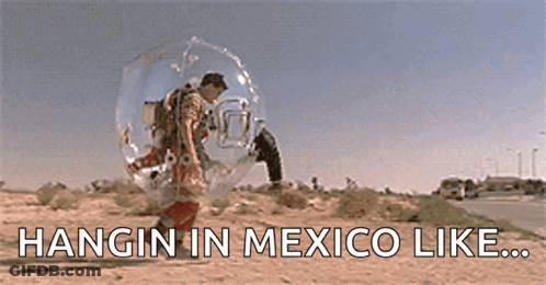 A Man Is Hanging In A Bubble In The Desert With The Words Hangin In Mexico Like Written Below Him . GIF