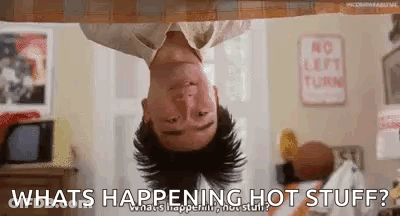 A Man Is Hanging Upside Down From A Ceiling And Asking What Is Happening Hot Stuff . GIF