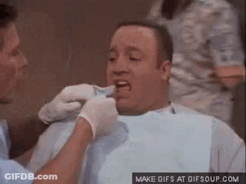 A Man Is Having His Teeth Examined By A Dentist In A Dental Chair . GIF