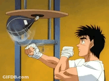 A Man Is Hitting A Punching Bag In A Boxing Ring . GIF