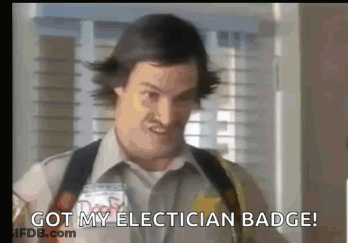 A Man Is Holding A Badge And Saying `` Got My Electrician Badge '' GIF