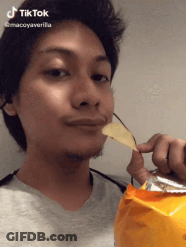 A Man Is Holding A Bag Of Chips In Front Of His Face And Says Tiktok GIF