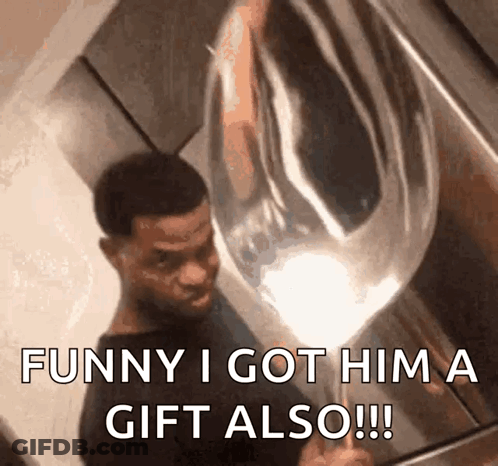 A Man Is Holding A Balloon That Says Funny I Got Him A Gift Also !!! GIF