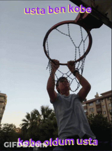 A Man Is Holding A Basketball Hoop With The Words Usta Ben Kobe Above Him GIF