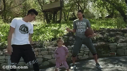 A Man Is Holding A Basketball While Two Other Men Are Dancing With A Little Girl . GIF